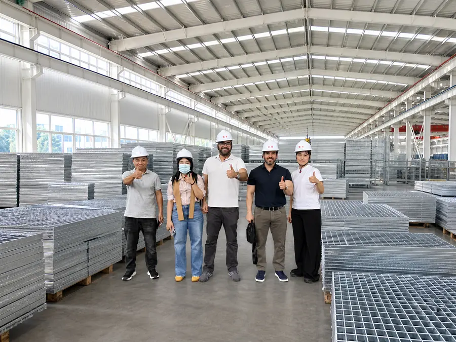 steel grating factory with international buyers inspecting galvanized panels