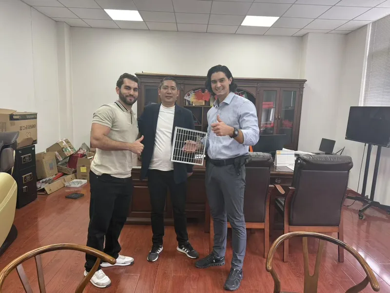 international buyers reviewing steel grating sample in office